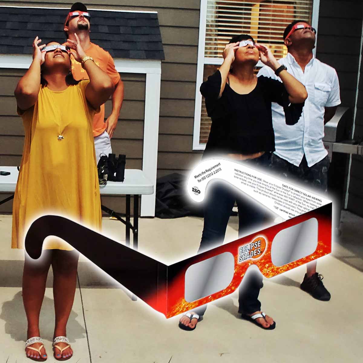 Group of people looking up using solar eclipse glasses